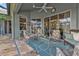 Spacious covered patio with comfortable seating and ceiling fan at 3589 Pennyroyal Rd, Port Charlotte, FL 33953
