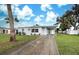 House exterior featuring a light gray color and a driveway at 2513 Elkcam Blvd, Port Charlotte, FL 33952