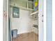 Small utility room with water heater and electrical panel at 2513 Elkcam Blvd, Port Charlotte, FL 33952