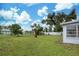 Large backyard, grassy area, and partially visible home at 2513 Elkcam Blvd, Port Charlotte, FL 33952