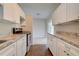 Clean and updated kitchen with white cabinets and stainless steel appliances at 2513 Elkcam Blvd, Port Charlotte, FL 33952