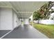 Covered carport with exterior storage and fenced backyard at 2513 Elkcam Blvd, Port Charlotte, FL 33952