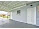 Covered carport with additional storage and exterior door at 2513 Elkcam Blvd, Port Charlotte, FL 33952