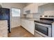 Updated kitchen featuring white cabinets, stainless steel appliances, and granite countertops at 2513 Elkcam Blvd, Port Charlotte, FL 33952