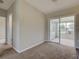 Room with sliding door to a sunroom and backyard at 2513 Elkcam Blvd, Port Charlotte, FL 33952