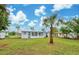 Spacious backyard with single-story home and palm tree at 2513 Elkcam Blvd, Port Charlotte, FL 33952