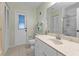 Bright bathroom with white vanity, exterior access, and shower at 10263 Waterford Ave, Englewood, FL 34224