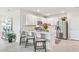 Well-lit kitchen featuring white cabinets, a stainless steel refrigerator, and a breakfast bar with seating at 16390 Bridle Ridge St, Port Charlotte, FL 33953