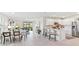 Open concept living and dining area flowing into a kitchen with white cabinets and stainless steel appliances at 16390 Bridle Ridge St, Port Charlotte, FL 33953