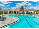 Stunning pool with ample seating, surrounded by lush landscaping, perfect for relaxation and recreation at 16390 Bridle Ridge St, Port Charlotte, FL 33953