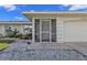 Front entrance with screened porch and landscaped garden at 17341 Sabrina Cir, Port Charlotte, FL 33948