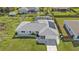 A captivating aerial view of a home featuring solar panels, screened-in lanai, and lush landscaping at 17341 Sabrina Cir, Port Charlotte, FL 33948