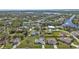 An aerial view of a neighborhood with lush greenery and waterfront properties in the distance at 17341 Sabrina Cir, Port Charlotte, FL 33948