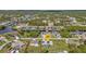 Aerial view showcases a home with a pool in a waterfront community, surrounded by lush landscaping and canals at 17341 Sabrina Cir, Port Charlotte, FL 33948