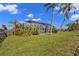 Palm trees surround the screened-in pool, offering shade and privacy to the property at 17341 Sabrina Cir, Port Charlotte, FL 33948
