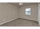 Neutral bedroom offers a ceiling fan, carpeting, and a window that offers exterior views at 17341 Sabrina Cir, Port Charlotte, FL 33948