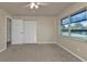 This bedroom features a closet, ceiling fan, a door, and neutral carpeting at 17341 Sabrina Cir, Port Charlotte, FL 33948