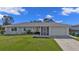 Well-kept one-story home featuring a single-car garage, manicured lawn, and neat landscaping at 17341 Sabrina Cir, Port Charlotte, FL 33948