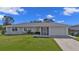 Well-kept one-story home featuring a single-car garage, manicured lawn, and neat landscaping at 17341 Sabrina Cir, Port Charlotte, FL 33948