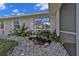 Charming home with beautiful landscaping, decorative rock accents, and a serene water feature at 17341 Sabrina Cir, Port Charlotte, FL 33948