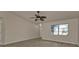 Bright living room featuring tile floors and a ceiling fan at 17341 Sabrina Cir, Port Charlotte, FL 33948