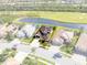 An aerial view of a luxurious property with a tile roof, landscaped yard, and pond views at 5241 Grand Palmetto Way, North Port, FL 34291