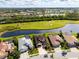 An aerial view of a house near a pond, a golf course and other homes at 5241 Grand Palmetto Way, North Port, FL 34291