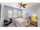 Cozy bedroom features natural light, ceiling fan, and comfortable furnishings at 5241 Grand Palmetto Way, North Port, FL 34291
