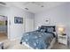 Comfortable bedroom with blue and white patterned bedding, neutral walls, and a ceiling fan at 5241 Grand Palmetto Way, North Port, FL 34291