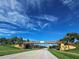 Bridge with community signage amidst lush greenery and blue skies at 5241 Grand Palmetto Way, North Port, FL 34291