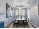 Elegant dining room with modern lighting and a large table perfect for hosting gatherings at 5241 Grand Palmetto Way, North Port, FL 34291