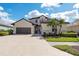 Beautiful two-story stucco home with tile roof, lush landscaping and a spacious driveway and two-car garage at 5241 Grand Palmetto Way, North Port, FL 34291