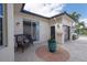 Charming patio with stylish seating and decorative accents, leading to the home's entrance at 5241 Grand Palmetto Way, North Port, FL 34291