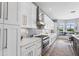 Well-appointed kitchen with white cabinets, stainless appliances, and a cozy breakfast nook with backyard views at 5241 Grand Palmetto Way, North Port, FL 34291