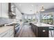 Gourmet kitchen features an island, modern appliances, and a breakfast nook with scenic views at 5241 Grand Palmetto Way, North Port, FL 34291