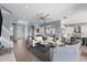 Spacious living room featuring a modern ceiling fan, neutral colors, and a view of the kitchen at 5241 Grand Palmetto Way, North Port, FL 34291