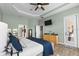 Spacious main bedroom features wood floors, tray ceilings, large windows and access to outdoor spaces at 5241 Grand Palmetto Way, North Port, FL 34291