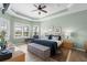Comfortable primary bedroom with tray ceilings, abundant natural light, and calming colors at 5241 Grand Palmetto Way, North Port, FL 34291
