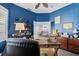 Blue office space with wood floors and desk, with an open view into the living room area at 5241 Grand Palmetto Way, North Port, FL 34291