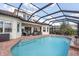 Relaxing backyard pool view featuring beautiful brick patio and screened-in enclosure at 5241 Grand Palmetto Way, North Port, FL 34291