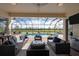 A beautiful screened-in pool with a gorgeous lake view and outdoor seating area at 5241 Grand Palmetto Way, North Port, FL 34291