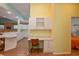 White kitchen cabinets, built-in desk and view into bedroom at 1274 White Oak Trl, Port Charlotte, FL 33948
