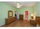 Bedroom with wood floors, ceiling fan and bathroom access at 1274 White Oak Trl, Port Charlotte, FL 33948