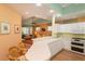 Open kitchen with breakfast bar and view of living room at 1274 White Oak Trl, Port Charlotte, FL 33948