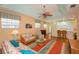Living room, kitchen and dining area view, wicker furniture and hardwood floors at 1274 White Oak Trl, Port Charlotte, FL 33948