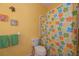 Bright bathroom with shower/tub combo and colorful shower curtain at 1274 White Oak Trl, Port Charlotte, FL 33948