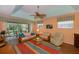 Living room with patio access, wicker furniture, and a ceiling fan at 1274 White Oak Trl, Port Charlotte, FL 33948