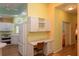Kitchen boasts white cabinets, built-in desk and breakfast bar at 1274 White Oak Trl, Port Charlotte, FL 33948