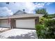 White garage door and American flag at 1274 White Oak Trl, Port Charlotte, FL 33948