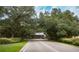 Entrance to a residential community with lush landscaping and a stop sign at 1274 White Oak Trl, Port Charlotte, FL 33948